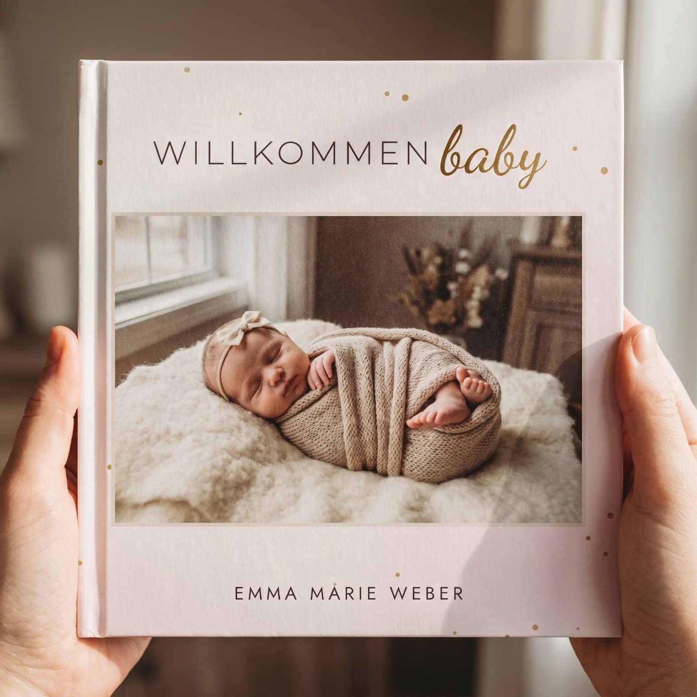 „Willkommen Baby" in zwei Händen, Nahaufnahme des Umschlags